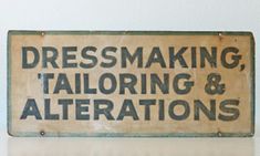 an old sign that says dressmaking, tailoring and alterations on the front