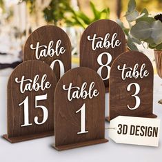 three wooden table numbers are shown on the table