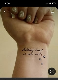 a woman's arm with a tattoo that reads, nothing loved is ever lost