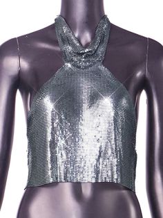 Metal halter turtleneck top. Trendy Fitted Mock Neck Top For Night Out, Disco Crop Top For Night Out, Disco Cropped Top For Night Out, Disco Style Crop Top For Night Out, Glamorous Halter Neck Tops For Night Out, Chic Turtleneck Top For Night Out, Glamorous Halter Neck Top For Party Season, Glamorous Halter Top For Spring Night Out, Glamorous Spring Halter Top For Night Out