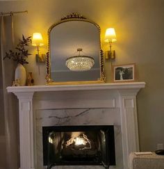 a living room with a fire place and a mirror on top of the fireplace mantel