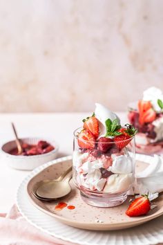 two desserts with strawberries and whipped cream