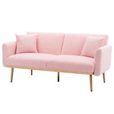 a pink couch sitting on top of a wooden frame