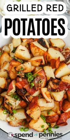 grilled red potatoes in a white bowl with green onions and bacon on the side