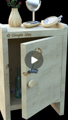 a wooden cabinet with an open door and flowers on it's side, in front of a black background