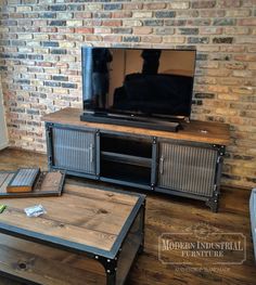 a living room with brick walls and a tv on top of a wooden coffee table