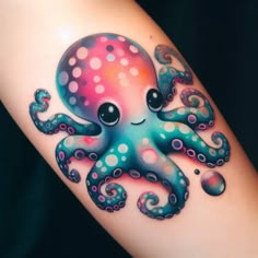 an octopus tattoo on the arm with polka dot dots and swirly colors in it