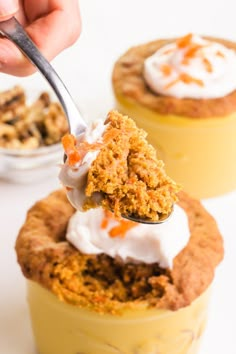 a person spooning some food out of a yellow cup filled with ice cream and toppings