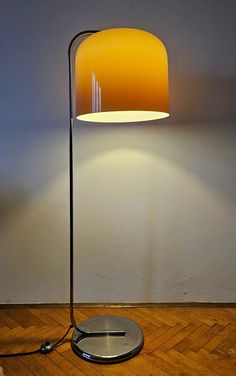 a lamp that is on top of a wooden floor