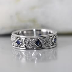 a white gold wedding band with blue sapphire stones