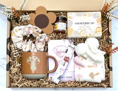 a gift box containing coffee, tea, books and other items for someone's special occasion