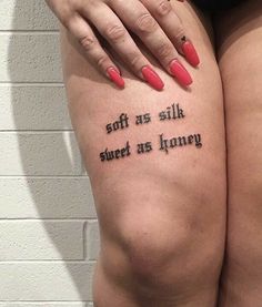 a woman's legs with words tattooed on them