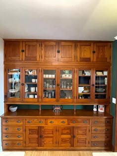 a large wooden china cabinet with glass doors