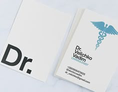 two business cards with the letter dr on them