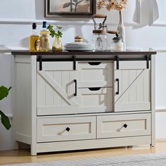 a white cabinet with two doors and drawers