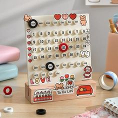 a wooden toy with buttons on it sitting on a table next to other toys and accessories