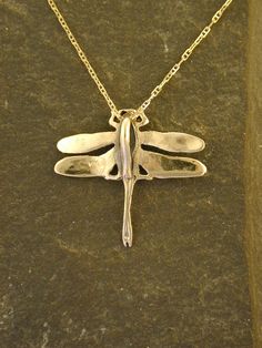 "I hand cast all my pieces using the lost wax casting method. This solid Dragonfly is 14K Gold. The included chain is a 14K Gold chain. You may chose 16, 18 or 20 inch at the same price. Other length available at sightly higher prices. The Dragonfly measures 1 1/8\" tall by 1 1/4\" across. Please ask your needs. You may call me with questions, often I am out so please use my machine. 831-476-3176. Satisfaction Guaranteed This piece takes me two to three weeks to make. This piece ships USPS First Gold Dragonfly Necklace For Gift, Nickel-free Gold Dragonfly Jewelry, Gold Nickel-free Dragonfly Earrings, Dragon Fly Pendant, Gold Wing-shaped Sterling Silver Necklace, Silver Heart Earrings, Wax Casting, French Wire, Sterling Silver Cross