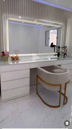 a large white vanity with a mirror and stool