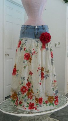 a woman's skirt with flowers on it is displayed in front of a door