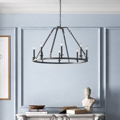 a chandelier hanging from the ceiling in a room with blue walls and furniture