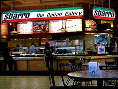 the italian eatery is open for business at night, with people waiting to order