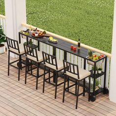 an outdoor table and chairs on a deck with grass in the backgroung