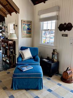 a blue chair and ottoman in a room