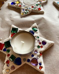 a white candle sitting on top of a table next to some ornaments and other decorations