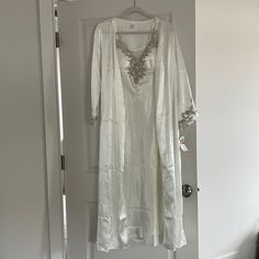 Beautiful, Never Worn Flora Bridal Gown And Robe. Size S. Gown: Lace Accents With Mesh On The Back. Bust Has Cups. Robe: Lace Accents On Sleeve. Full Length. String Closure. Original Price $134. Tags Still Attached. Selling As A Set. White Silk Kaftan For Festive Occasions, Elegant White Gown For Eid, White Silk Long Sleeve Sleepwear, White Silk Long-sleeve Sleepwear, White Satin Sets For Wedding Night, White Evening Gown For Eid, White Floor-length Evening Set, Festive White Silk Gown, Elegant Robe For Mother Of The Bride