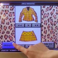 a person is pointing at an image on a television screen that has clothes on it