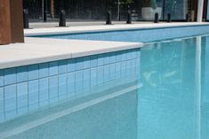 an empty swimming pool with blue tiles and no people in the water or onlookers