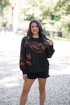 Black terry knit pullover accented with embroidered footballs and 'touchdown' In the Fall we are all Touchdown Obsessed!! Show your gameday spirit in this fabulous black sweatshirt, featuring brown embroidery braided footballs and the word 'touchdown' on the front and down the sleeves. With a crew neckline and long balloon sleeves, she's as comfy as she is festive. Tailgating never looked so stylish! True to size fit; relaxed silhouette Model is 5'5" wearing a small Fabric contains stretch Ribbe Football Party Outfit, Tailgating Outfits, Shoulder Embroidery, Brown Embroidery, Tailgate Outfit, Graphic Tee Dress, Football Sweatshirt, Football Party, Vintage Couture