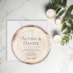 a wooden slice with candles and greenery on it