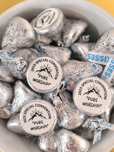 a bowl filled with silver foil covered chocolate candies