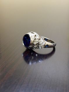 DeKara Designs Clearance Metal- 14K Yellow Gold, .583. Stones- Center 1 Round Ceylon Blue Sapphire 2.25 Carats, 2 Round Sapphire 0.05 Carats, 40 Diamonds G Color VS2 Clarity, 0.72 Carats. Size- Ring is a 6, and could be sized up or down at no additional cost! FREE SIZING Want the ring entirely hand engraved? No problem! Just go to the following link... https://www.etsy.com/listing/280526214/art-deco-14k-white-gold-sapphire-diamond?ga_search_query=sapphire+ring&ref=shop_items_search_8 Art Dec Luxury Sapphire Wedding Ring With Cubic Zirconia, Luxury Sapphire Ring With Cubic Zirconia For Wedding, Heirloom Blue Diamond Ring With Accents, Heirloom Blue Diamond Ring In 14k White Gold, Exquisite Round Cut Sapphire Wedding Ring, Luxury Lab-created Sapphire Ring For Formal Occasions, Exquisite Sapphire Ring For Wedding, Heirloom Blue Sapphire Ring With Diamond Accents, Luxury Cluster Ring With Sapphire In Round Cut