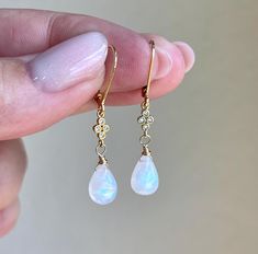 Rainbow Moonstone Earrings, Teardrop Dangle Earrings, Minimalist Gold Earrings, June Birthstone, Small Moonstone Earrings, Gift for women These precious delicate earrings feature blue flash rainbow moonstone smooth teardrops adorned with a white topaz connector in either gold or silver finish. The earrings are suspended from lever back ear wires in gold filled or sterling silver. These earrings are very feminine and subtle, perfect for every day and the moonstone makes them suitable for almost a Moonstone Birthstone, Moonstone Properties, Minimalist Gold Earrings, Bridal Party Jewelry, Minimalist Earrings Gold, Silver Gift Wrap, Freshwater Pearl Jewelry, Earrings Gemstone, Earrings Teardrop