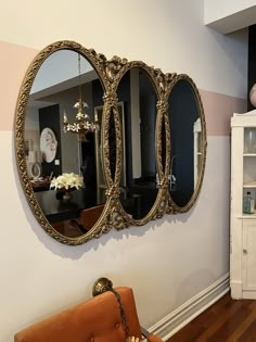 a mirror hanging on the wall above a couch