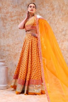 Yellow lehenga featuring bouquet print and gota embellished border. Paired with a printed blouse and a sheer dupatta with a border print., Fit: Relaxed Wedding Lehenga With Printed Motifs For Diwali, Bollywood Wedding Choli With Printed Motifs, Fitted Wedding Choli With Printed Motifs, Wedding Lehenga With Printed Motifs For Festivals, Wedding Choli With Printed Motifs For Navratri, Wedding Choli With Printed Motifs, Orange Lehenga With Motifs For Wedding, Festive Wedding Lehenga With Printed Motifs, Orange Wedding Lehenga With Motifs