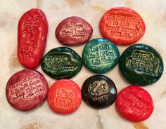 six different colored rocks with writing on them