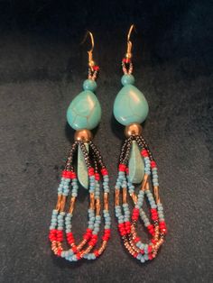 These are made with imitation turquoise as far as the tear drops are concerned , however the  turquoise bead at the top, and the almost crystal shaped turquoise hanging in the center is real .  I have made these earrings. I am an enrolled member of a federally recognized Tribe. I had a Etsy store before, my Husband and I had  a great time making items to stock our store. Met amazing people! I had to shut it down because of my husband's illness, I was his caregiver. I lost my partner, and best friend in January 2024. So this will be my first time doing this solo. Bohemian Teardrop Earrings With Colorful Beads, Beaded Dangle Teardrop Earrings For Festivals, Adjustable Turquoise Chandelier Earrings With Dangling Beads, Bohemian Adjustable Teardrop Earrings With Colorful Beads, Artisan Teardrop Beaded Earrings With Dangling Beads, Adjustable Bohemian Teardrop Earrings With Colorful Beads, Bohemian Teardrop Dangle Earrings With Colorful Beads, Bohemian Colorful Beaded Teardrop Earrings, Adjustable Blue Bohemian Teardrop Earrings