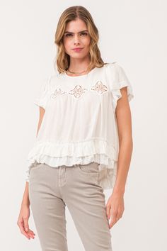 image of a female model wearing a VADA EMBROIDERY MOTIF BLOUSE WHITE DEAR JOHN DENIM Spring Casual Blouse With Cutwork Hem, Feminine Spring Tops With Cutwork Hem, Feminine Spring Top With Cutwork Hem, White Broderie Anglaise Lace Top With Short Sleeves, White Ruffle Sleeve Blouse With Lace Trim, White Blouse With Lace Trim And Ruffle Sleeves, Summer Short Sleeve Tops With Broderie Anglaise, Bohemian Broderie Anglaise Short Sleeve Blouse, Spring Cotton Ruffle Short Sleeve Top