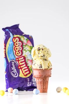 two scoops of ice cream next to a bag of candy