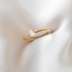 A simple gold ring featuring a genuine moonstone (4mm in diameter). The natural blue flash of the moonstone is visible depending on the light and angle. This ring is 14k gold filled and is hypoallergenic, water-resistant, and tarnish-resistant. --------------------♥ PROMOS ♥-------------------- Want 10% off? Join the mailing list by visiting http://bit.ly/vedern . --------------------♥ BUY WITH CONFIDENCE ♥-------------------- Don't love it? Message me to set up a return or exchange. If you find Rings Moonstone, Simple Gold Ring, Please Don't Leave, Dainty Gold Ring, Dainty Band, Gold Rings Simple, Dainty Gold Rings, Zierlicher Ring, Promise Ring Gift