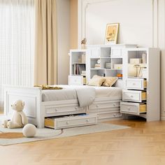 a bedroom with a white bed, dresser and bookcases in front of a window