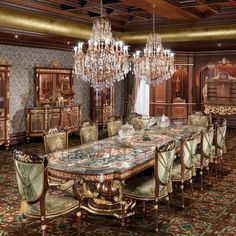 an ornate dining room with chandelier and table in the middle, surrounded by chairs