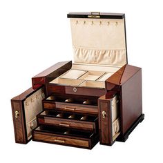 an open wooden jewelry box with drawers