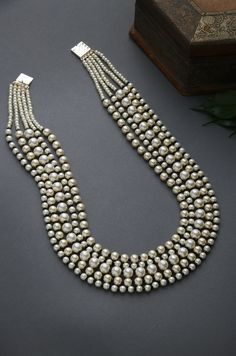 Black-White Gold Tone Beaded Necklace.Elegant and modern,White beaded necklace will complete your lavish ensemble grandeur. Necklace Size - 24 inches. Closure - Adjustable Style Tip - We love teaming this with classy chiffon sarees or zari silk sarees. Also looks best when worn with your royal whites, off whites and gold. We recommend styling with pastel solids or floral dresses in peachy pink, pistachio green and pastel blue too. Handcrafted in Jammu and Kashmir Paisley Pop travels the depths o Elegant Bridal Necklace With Large Round Beads, Elegant Large Bead Pearl White Necklace, Elegant Pearl White Necklace With Large Beads, Elegant Large Beaded Pearl White Necklace, Festive White Pearl Necklace With Polished Beads, White Pearl Chain Beaded Necklaces Temple Jewelry, Elegant Multi-strand Silver Beads, Temple Jewelry Pearl Chain Beaded Necklace, Temple Style Pearl Beaded Necklaces