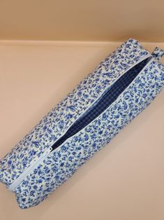 a blue and white flowered bag sitting on top of a table