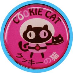 a pink button with an image of a cat holding a mouse in it's hand