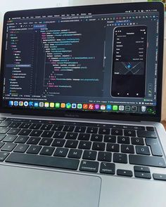 an open laptop computer sitting on top of a wooden table